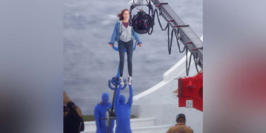 Natalie Portman being hoisted by stuntmen in blue screen suits on the set of Thor: Love and Thunder